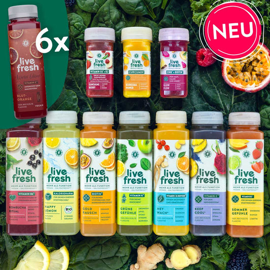 iveFresh Sortiment aus 12 kaltgepressten Säften und Shots, darunter die limitierte „Winter Edition“ mit Blutorange (6x), Shots mit Vitamin D3 + K2, Curcumin, Zink + Biotin sowie größere Flaschen wie „Kombucha Ritual“, „Happy Lemon“, „Gold Rausch“, „Grüne Gefühle“, „Hey Wach“, „Keep Cool“ und „Sommer Gefühle“. Umgeben von frischem Obst, Ingwer und grünem Blattgemüse, mit pinkem „NEU“-Sticker oben rechts.